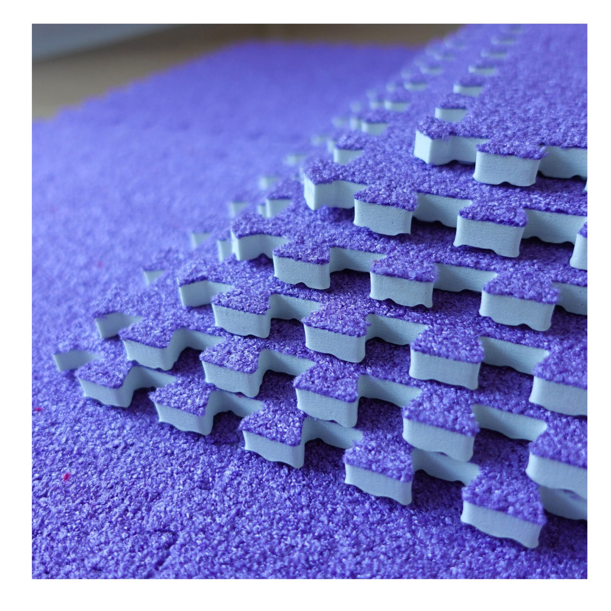 Close-up of the violet SOFT carpet puzzle surface and interlocking edges